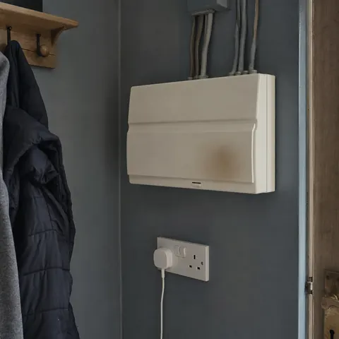 Consumer unit with a faint scorch mark near the front door