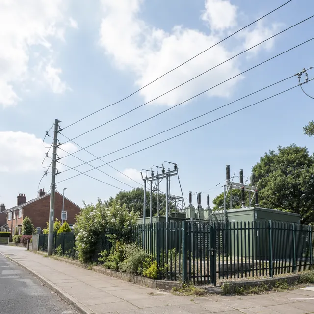 Electricity substation behind railings on a residential street