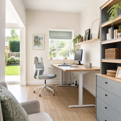Home office desk with a computer, monitor and chargers