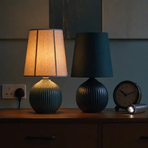 Two table lamps on a sideboard with one lit and one off
