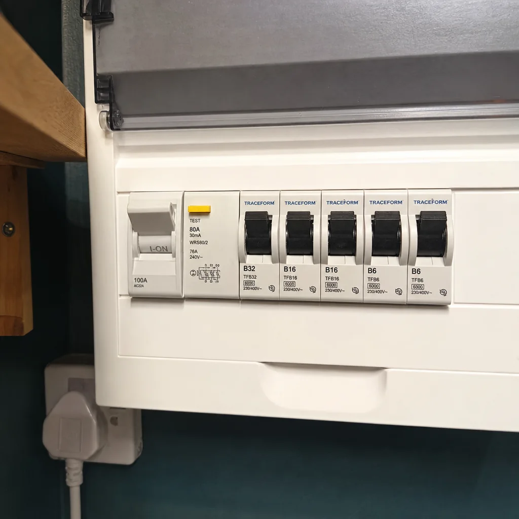 Close-up of RCDs and circuit breakers inside a modern consumer unit