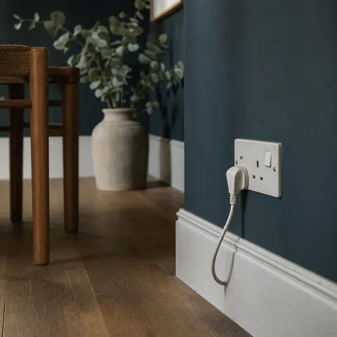Charger flex hanging from a loose wall socket