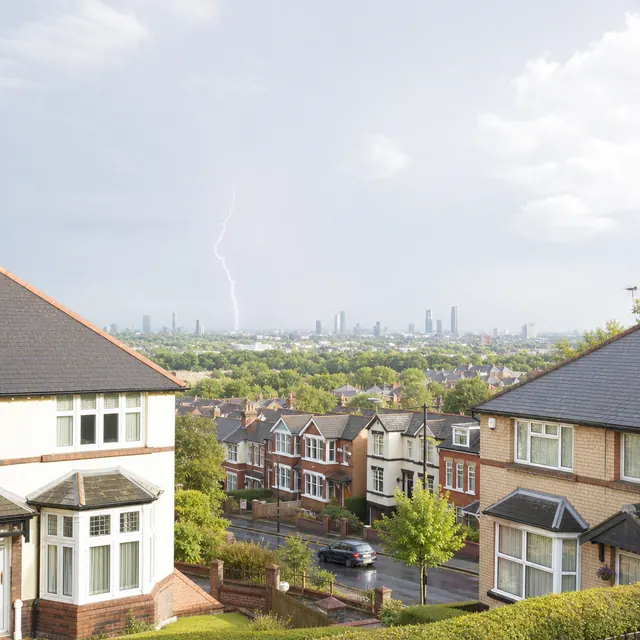 Lightning over rooftops in Greater Manchester during a storm